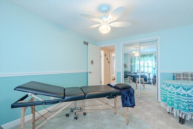 interior space with a closet, visible vents, light carpet, ceiling fan, and baseboards