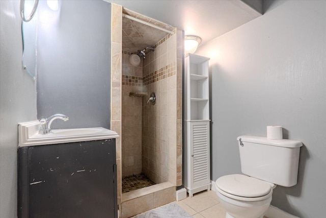 full bathroom with a stall shower, tile patterned flooring, vanity, and toilet