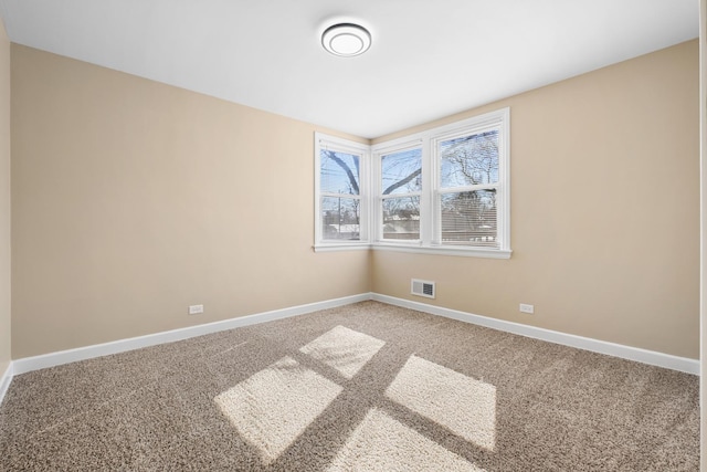 unfurnished room with baseboards, visible vents, and carpet flooring