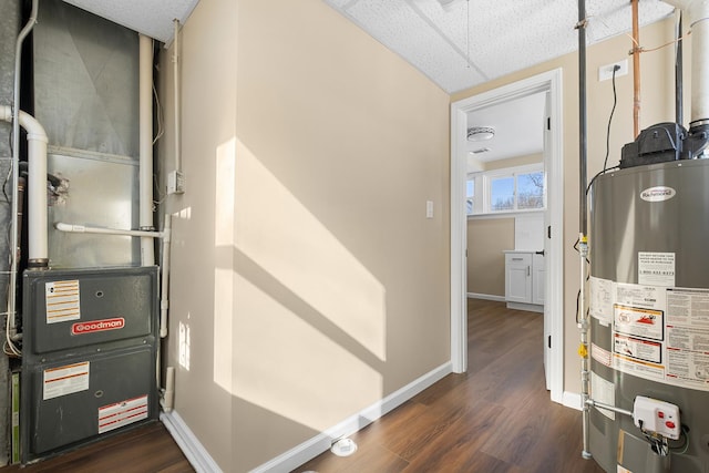 utility room with heating unit and water heater