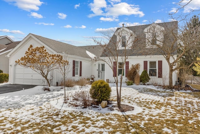 view of front of home with a shingled roof, driveway, and an attached garage