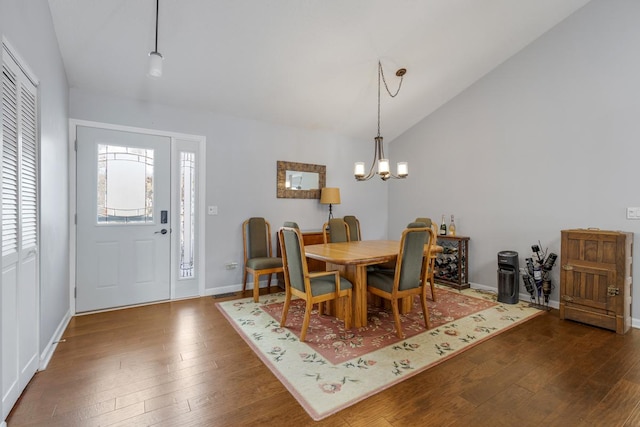 dining area featuring baseboards, a chandelier, vaulted ceiling, and dark wood finished floors