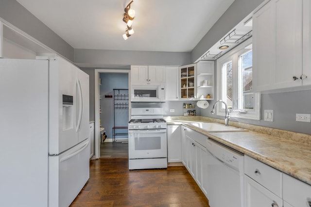 kitchen with white appliances, a sink, white cabinetry, light countertops, and glass insert cabinets