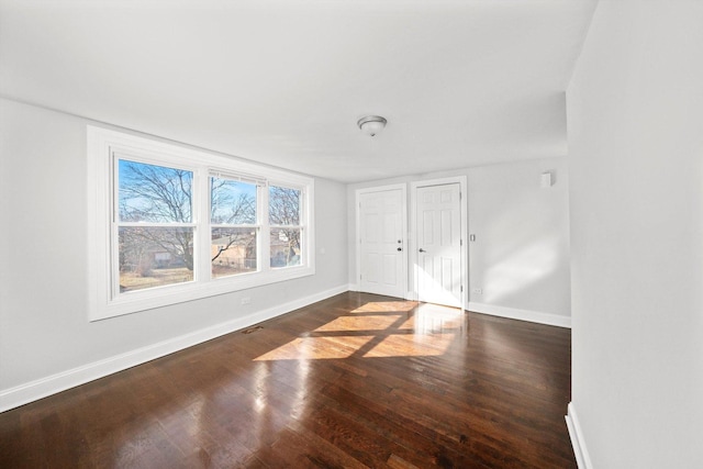 interior space featuring wood finished floors and baseboards