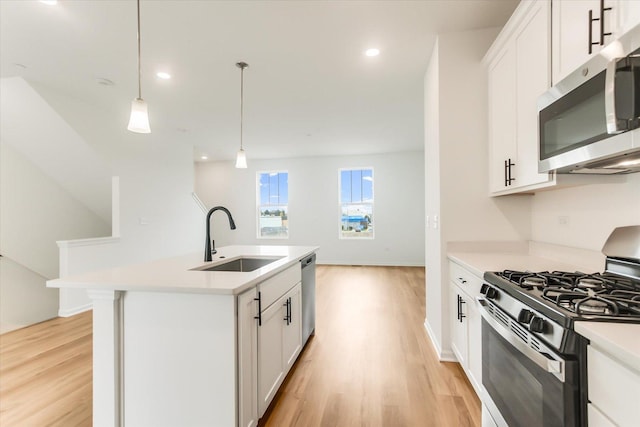 1121 Girard Ave, Des Plaines, IL 60018 - kitchen featuring stainless steel appliances, a sink, light wood-type flooring, light countertops, and pendant lighting