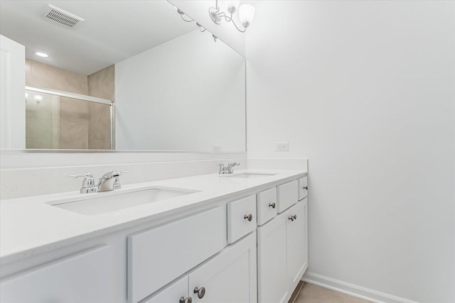 1121 Girard Ave, Des Plaines, IL 60018 - bathroom with a tile shower, double vanity, baseboards, and tile patterned floors
