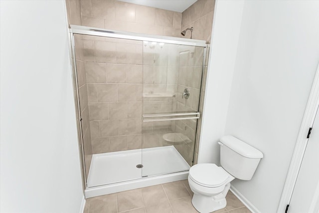 1121 Girard Ave, Des Plaines, IL 60018 - bathroom featuring tile patterned floors, toilet, a stall shower, and baseboards