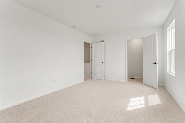 1121 Girard Ave, Des Plaines, IL 60018 - unfurnished bedroom with light carpet, multiple windows, and baseboards