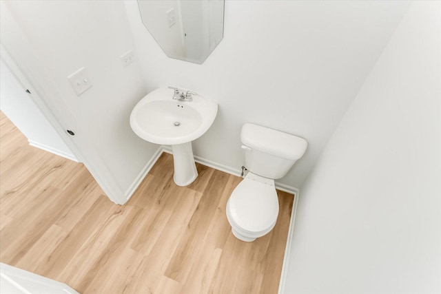 1121 Girard Ave, Des Plaines, IL 60018 - half bathroom featuring wood finished floors, baseboards, and toilet