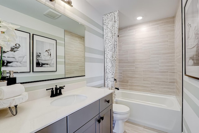 bathroom featuring toilet, washtub / shower combination, visible vents, and vanity