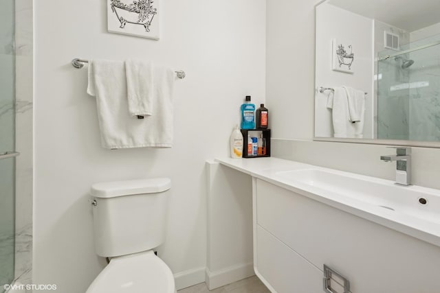 full bathroom with a marble finish shower, baseboards, visible vents, toilet, and vanity