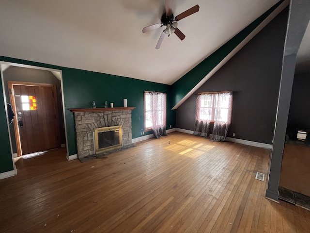 unfurnished living room with visible vents, baseboards, a ceiling fan, wood-type flooring, and a fireplace