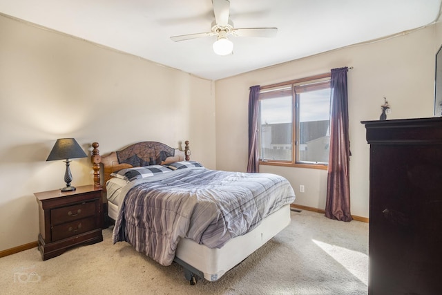 bedroom with light carpet, ceiling fan, and baseboards