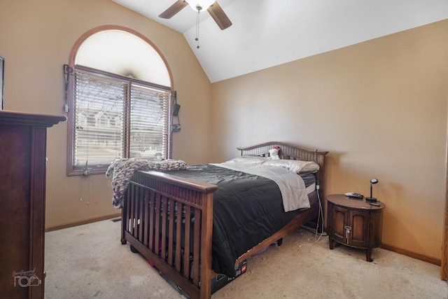 carpeted bedroom featuring baseboards, vaulted ceiling, and a ceiling fan