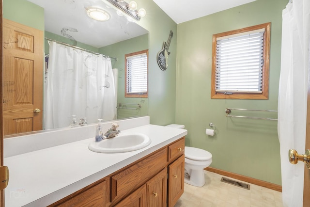 full bathroom with toilet, vanity, visible vents, baseboards, and tile patterned floors