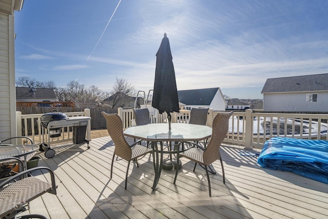 wooden deck featuring a residential view and outdoor dining space