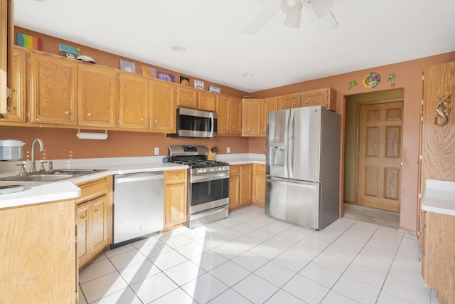 kitchen featuring ceiling fan, appliances with stainless steel finishes, light countertops, and a sink