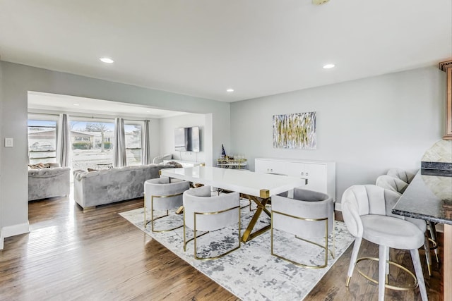 dining room featuring recessed lighting, baseboards, and wood finished floors