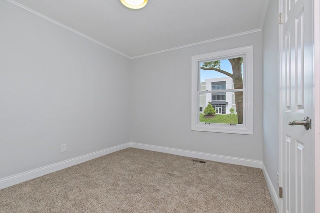 carpeted empty room featuring crown molding, visible vents, and baseboards