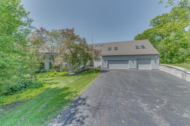 view of front of house with a garage and a front yard