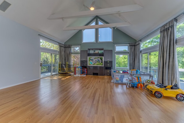 game room with high vaulted ceiling, light wood finished floors, beamed ceiling, and a wealth of natural light