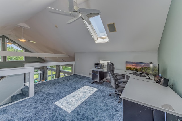 home office featuring lofted ceiling with skylight, dark colored carpet, and a ceiling fan