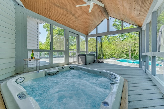 view of pool with hot tub deck surround