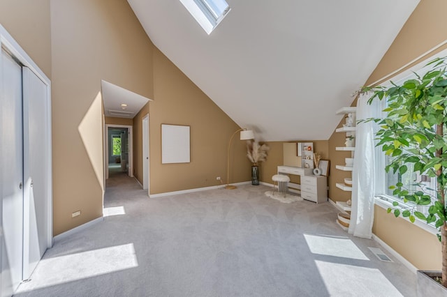 bonus room featuring lofted ceiling with skylight, light colored carpet, visible vents, and baseboards