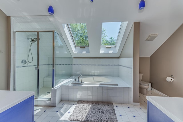 full bathroom with vaulted ceiling with skylight, toilet, vanity, a shower stall, and a bath