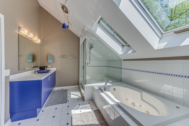 full bath with a stall shower, vaulted ceiling with skylight, vanity, and a tub with jets