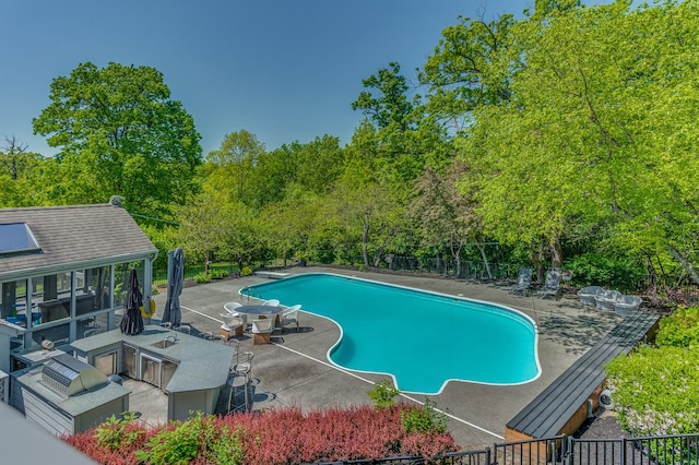 view of swimming pool with a diving board, a patio, fence, and a fenced in pool