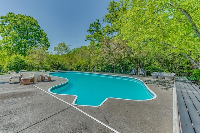 outdoor pool with a patio area