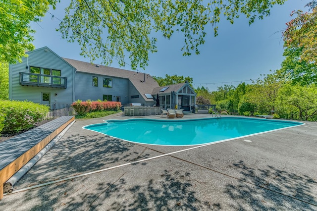 outdoor pool with a patio area and fence