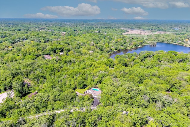 drone / aerial view with a water view and a wooded view