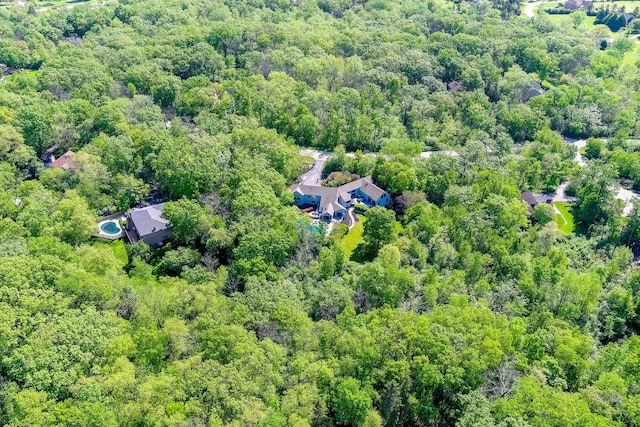 birds eye view of property with a view of trees