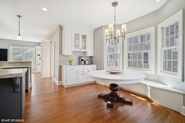 dining space with light wood finished floors, baseboards, an inviting chandelier, and recessed lighting