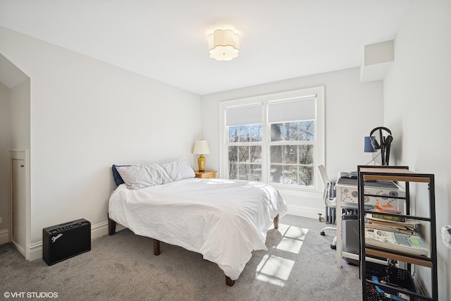 carpeted bedroom featuring baseboards