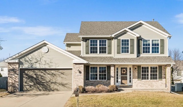 view of front of property with driveway, a shingled roof, a garage, and brick siding