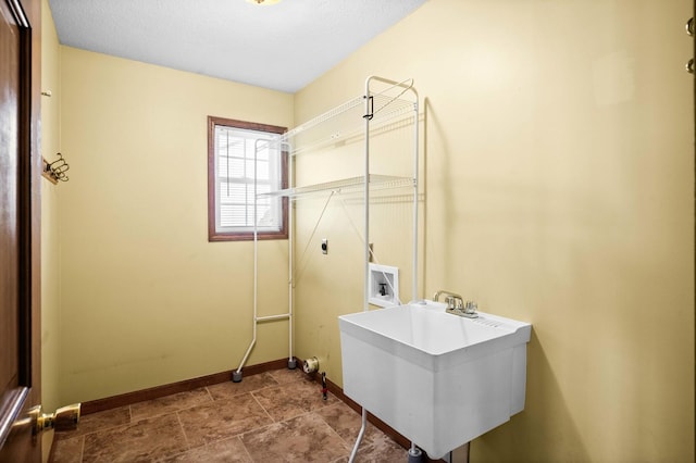 laundry area with hookup for an electric dryer, laundry area, washer hookup, a sink, and baseboards