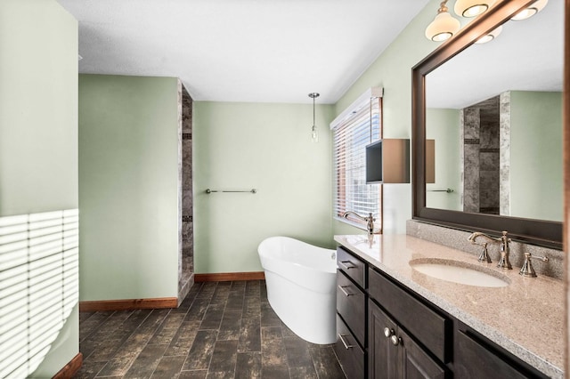 full bathroom with a soaking tub, vanity, wood finished floors, baseboards, and walk in shower