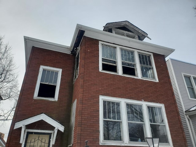 view of side of property with brick siding