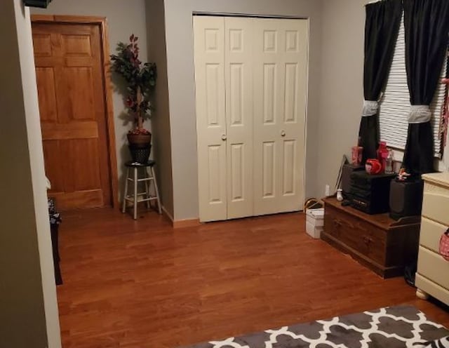 bedroom featuring a closet and dark wood finished floors