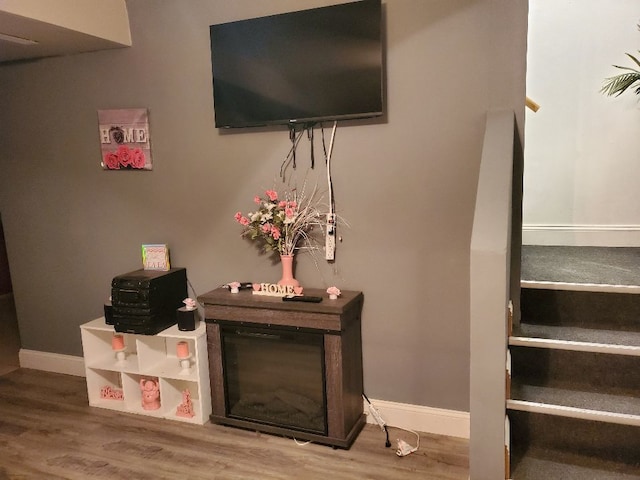 interior space with baseboards and wood finished floors