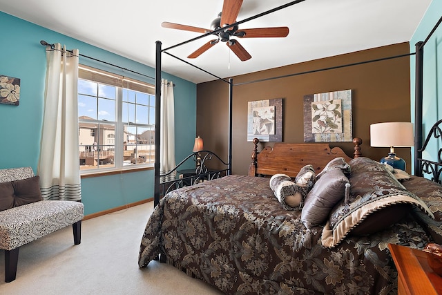 bedroom featuring baseboards, a ceiling fan, and light colored carpet