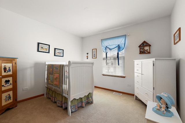 bedroom with light carpet, visible vents, and baseboards