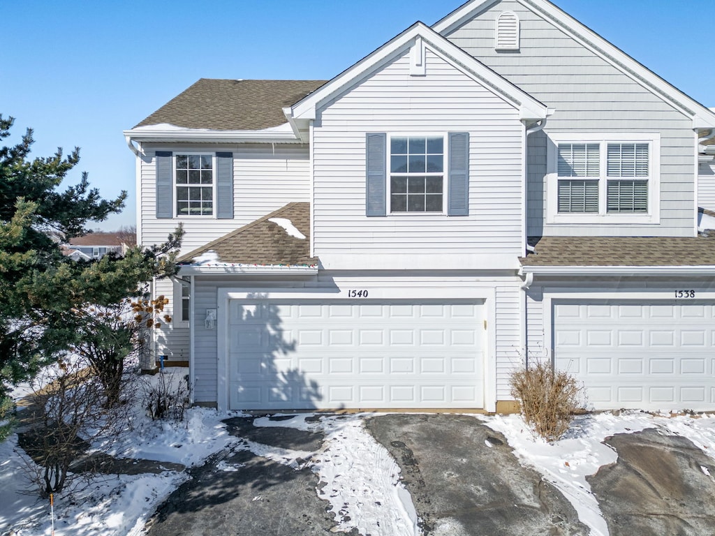 view of front of home featuring a shingled roof and an attached garage