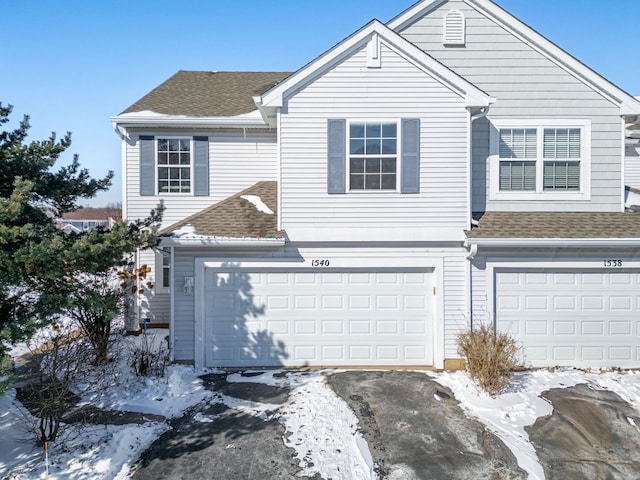 view of front of home featuring a shingled roof and an attached garage