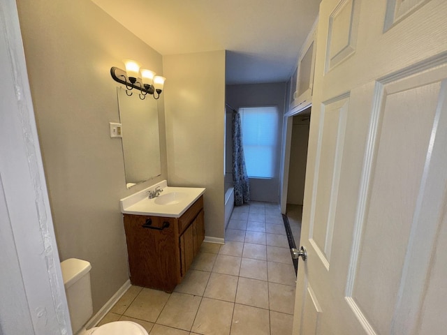 bathroom with tile patterned flooring, toilet, vanity, baseboards, and shower / bath combination with curtain