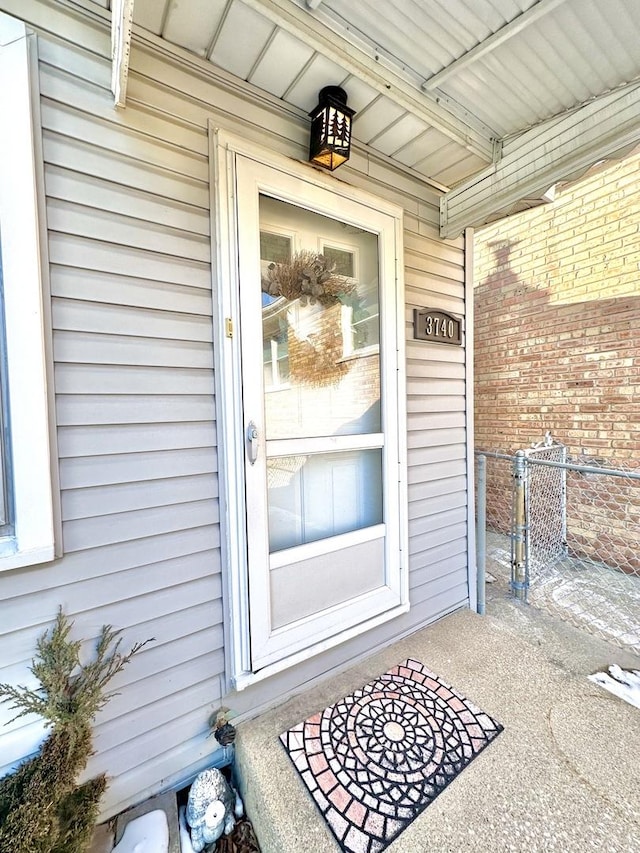 entrance to property featuring fence