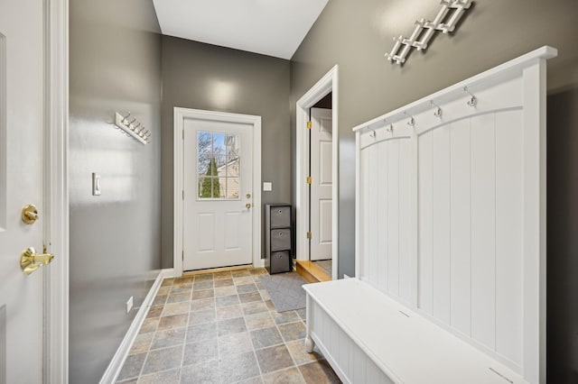 mudroom featuring stone finish floor and baseboards